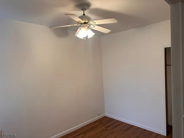 a view of a small space with wooden floor and a window