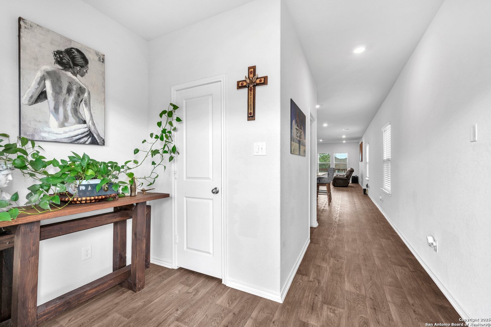 14016 Breccia Loop San Antonio, TX 78253 - Photo 4 of 31 a hallway with wooden floor and paintings on the wall