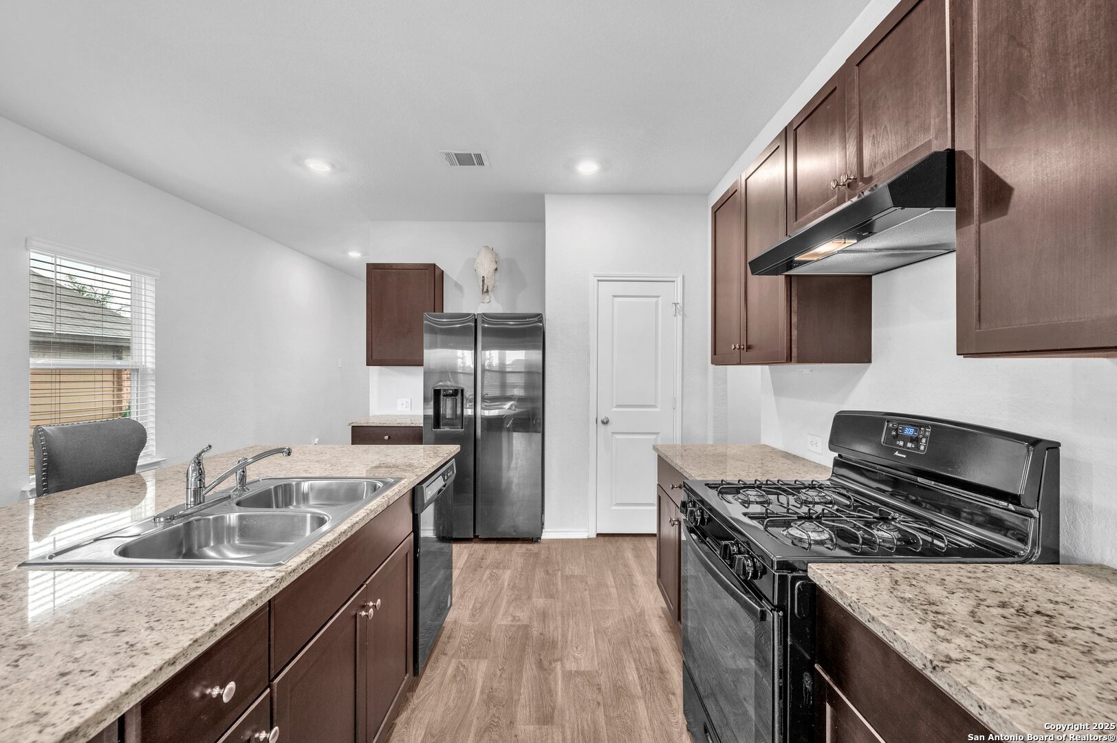 14016 Breccia Loop San Antonio, TX 78253 - Photo 6 of 31 a kitchen with stainless steel appliances granite countertop a sink stove and refrigerator