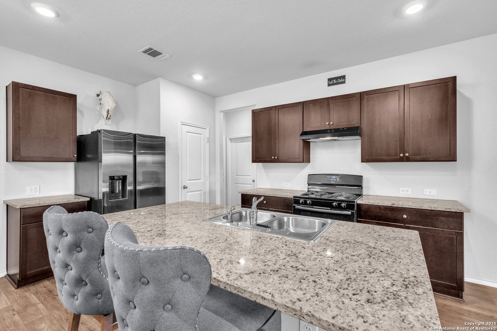 14016 Breccia Loop San Antonio, TX 78253 - Photo 7 of 31 a kitchen with stainless steel appliances granite countertop a sink stove and refrigerator