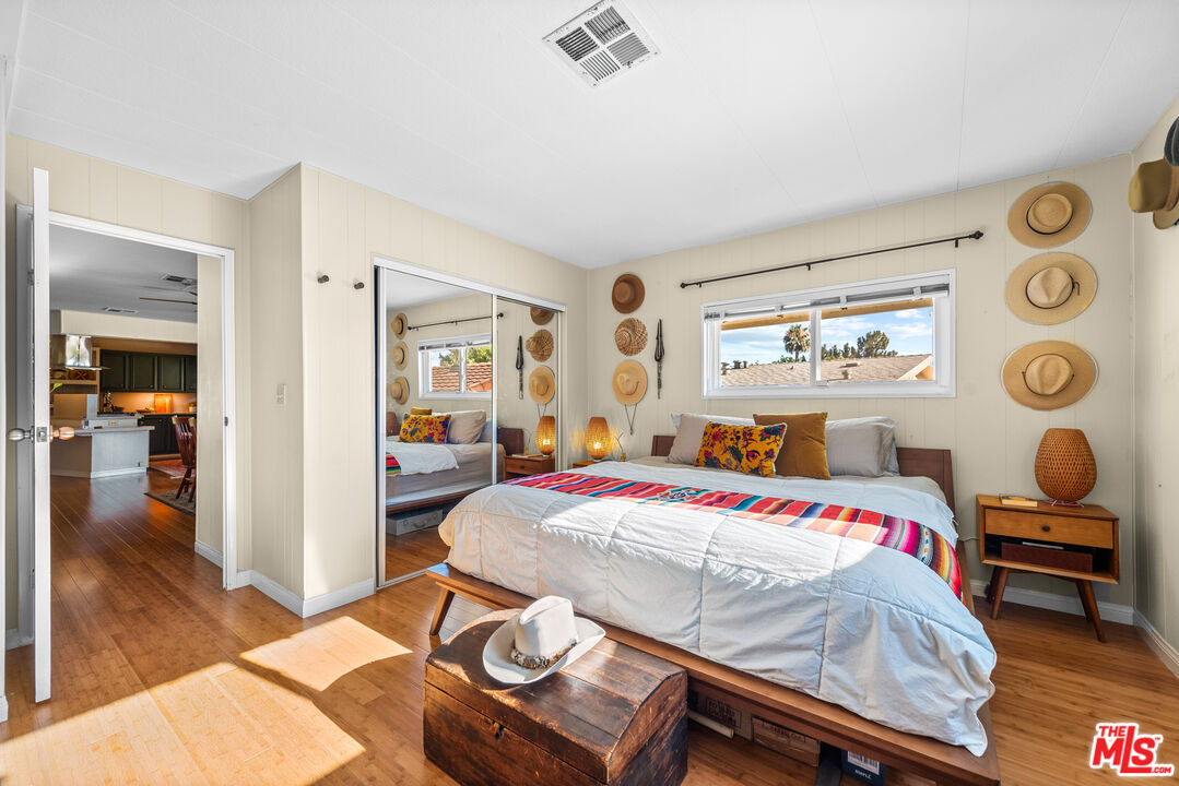 1205 Supi Topanga, CA 90290 - Photo 11 of 24 a bedroom with a bed and wooden floor