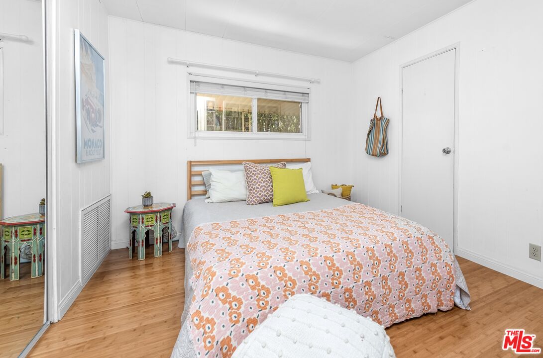 1205 Supi Topanga, CA 90290 - Photo 14 of 24 a bedroom with a bed and wooden floor
