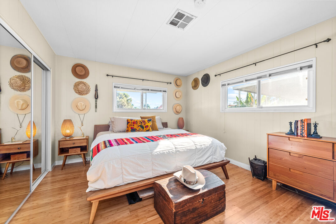 1205 Supi Topanga, CA 90290 - Photo 10 of 24 a bedroom with a bed and a dresser next to a window