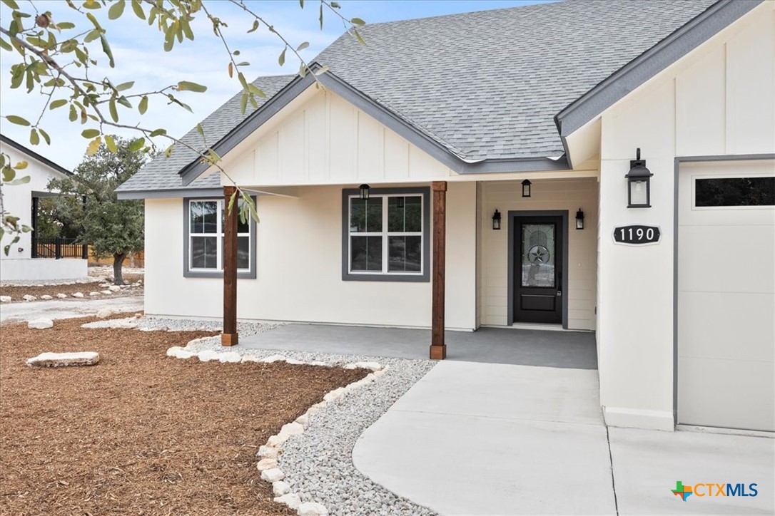 1190 Fernwood Road Fischer, TX 78623 - Photo 1 of 27 a front view of a house with a garage