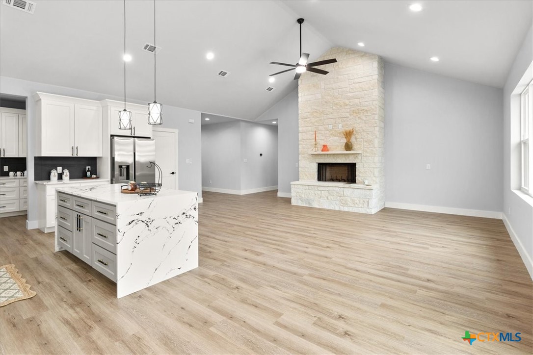 1190 Fernwood Road Fischer, TX 78623 - Photo 17 of 27 a kitchen with stainless steel appliances kitchen island hardwood floor sink stove and kitchen view