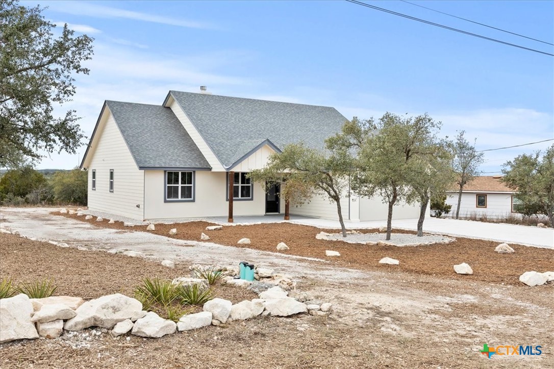1190 Fernwood Road Fischer, TX 78623 - Photo 2 of 27 a front view of a house with a yard