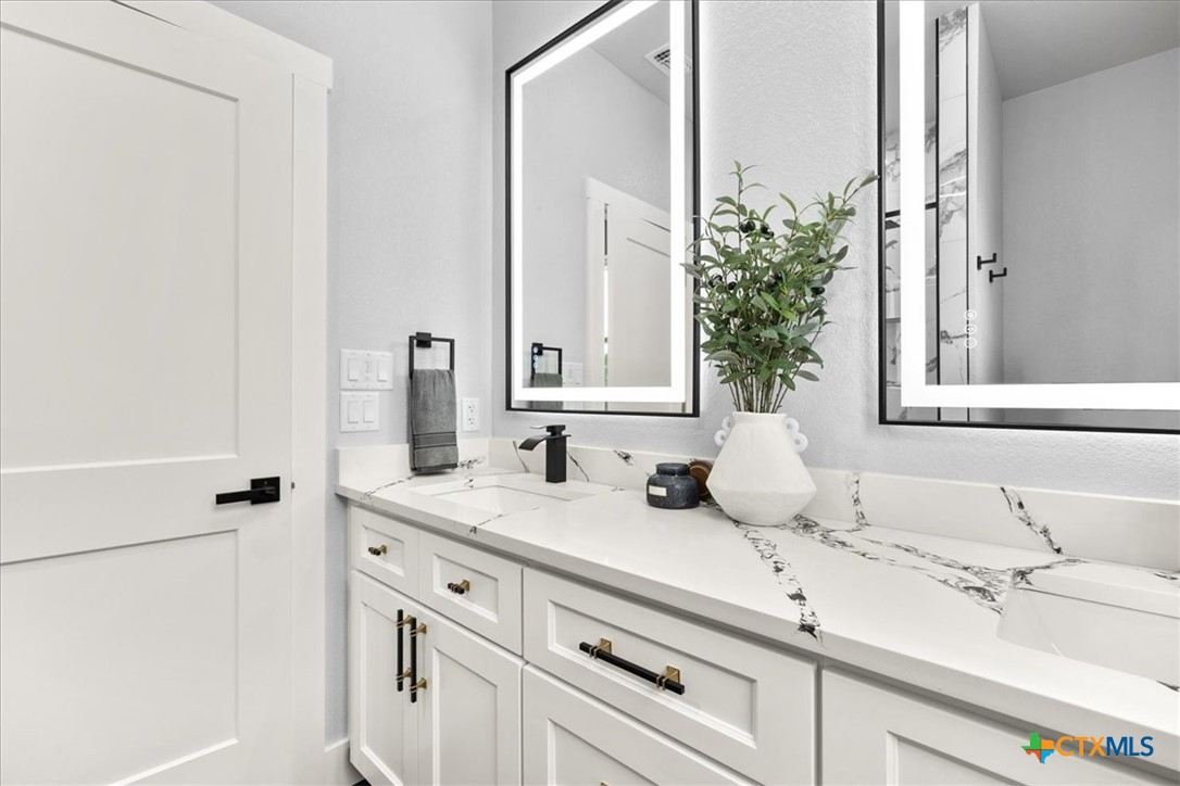 1190 Fernwood Road Fischer, TX 78623 - Photo 23 of 27 a bathroom with a sink and a mirror