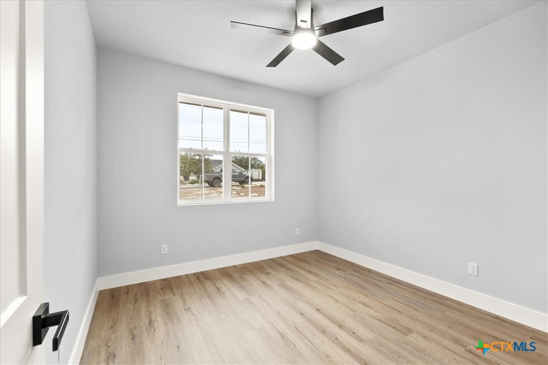 1190 Fernwood Road Fischer, TX 78623 - Photo 25 of 27 an empty room with a window and a ceiling fan