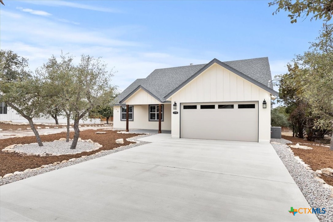 1190 Fernwood Road Fischer, TX 78623 - Photo 4 of 27 a front view of a house with a yard and garage