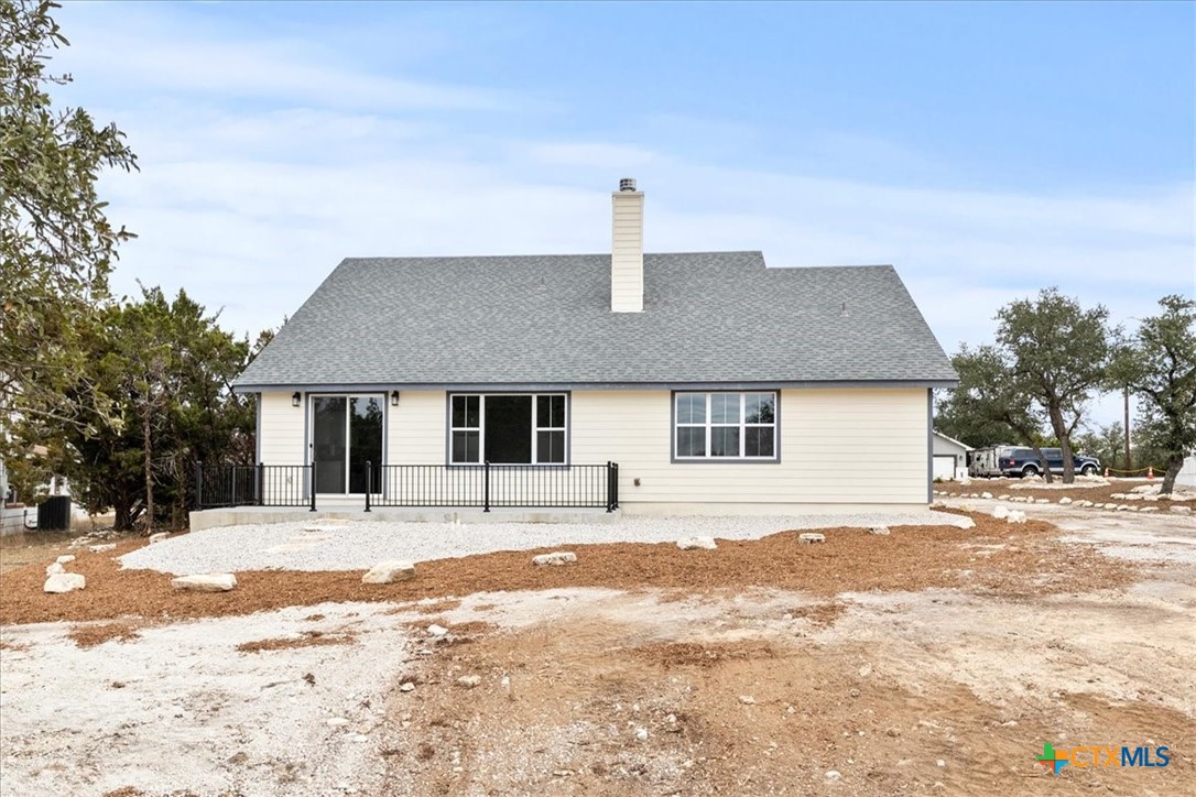 1190 Fernwood Road Fischer, TX 78623 - Photo 6 of 27 a front view of a house with a yard covered with snow
