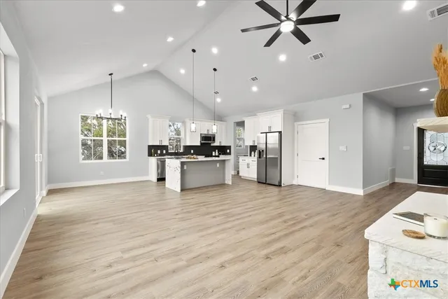 a view of kitchen with cabinets and wooden floor