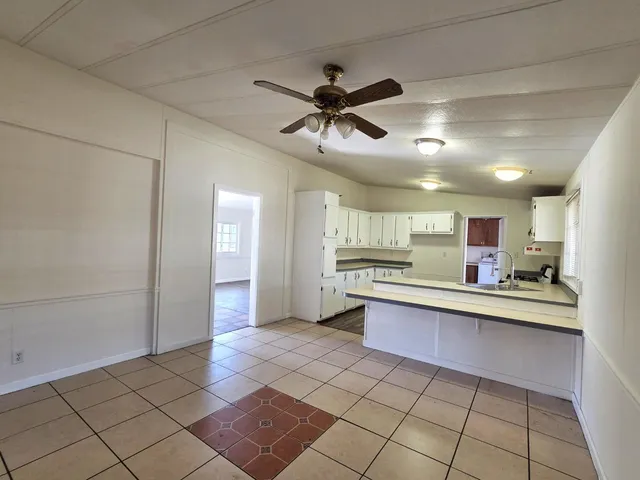 a kitchen with stainless steel appliances a refrigerator and cabinets