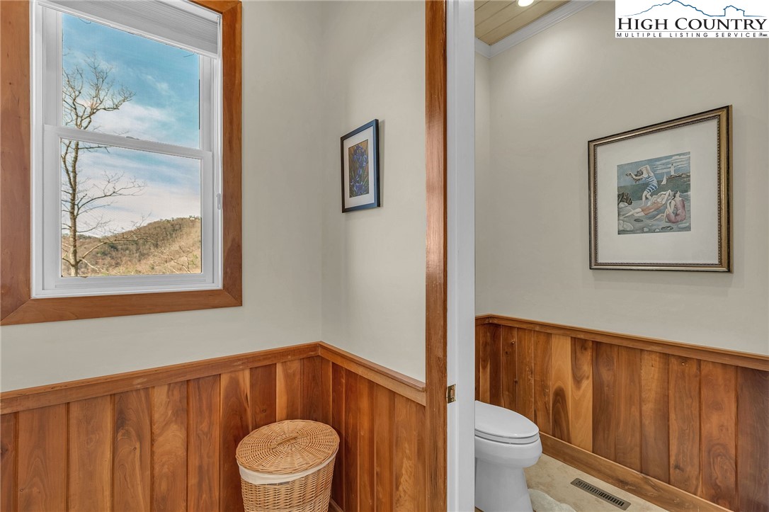 933 Thunder Ridge Lane Lenoir, NC 28645 - Photo 26 of 45 a bathroom with a toilet and a painting on the wall
