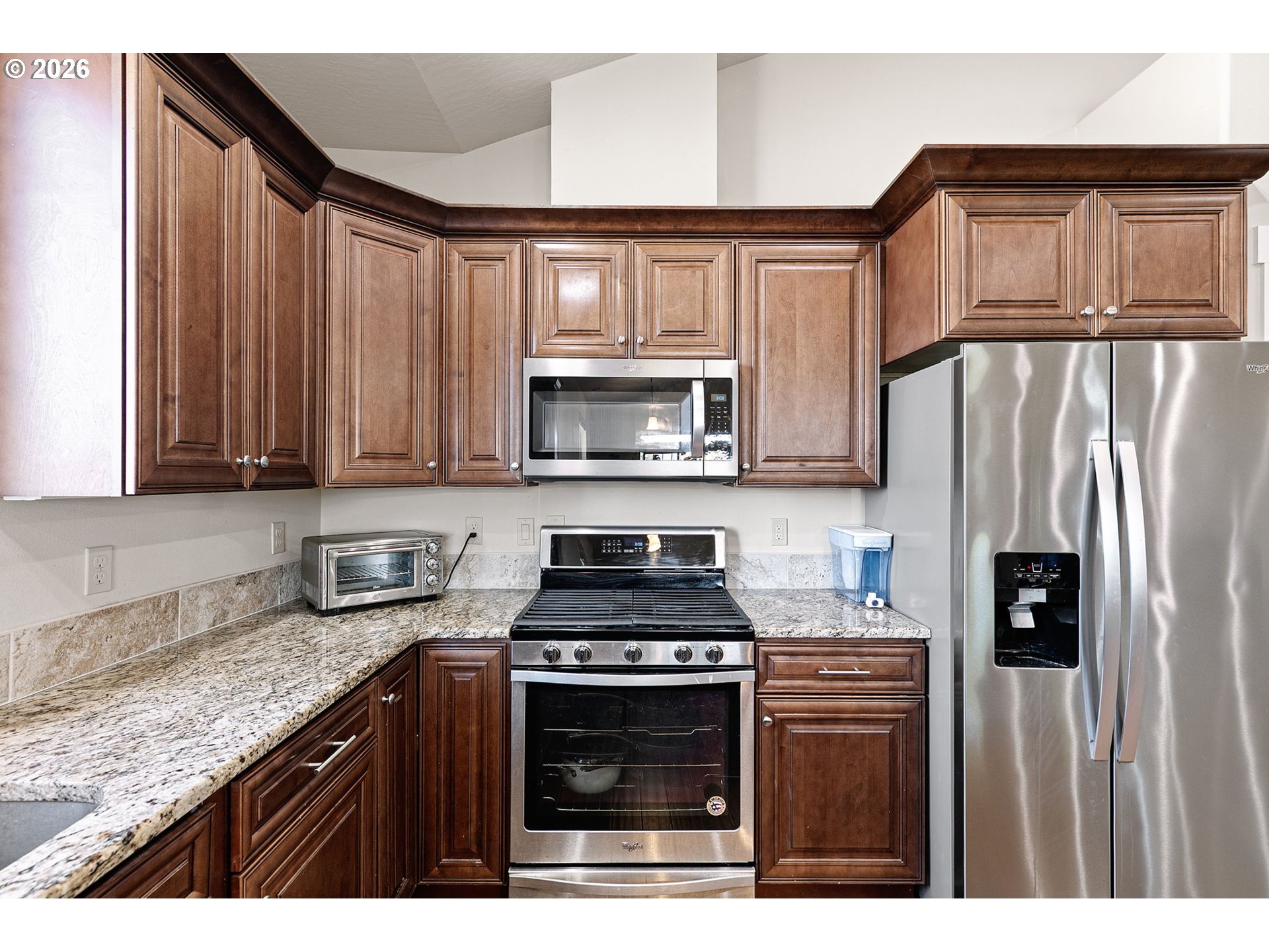 6451 Dogwood Street Springfield, OR 97478 - Photo 13 of 38 a kitchen with granite countertop a stove top oven microwave and refrigerator