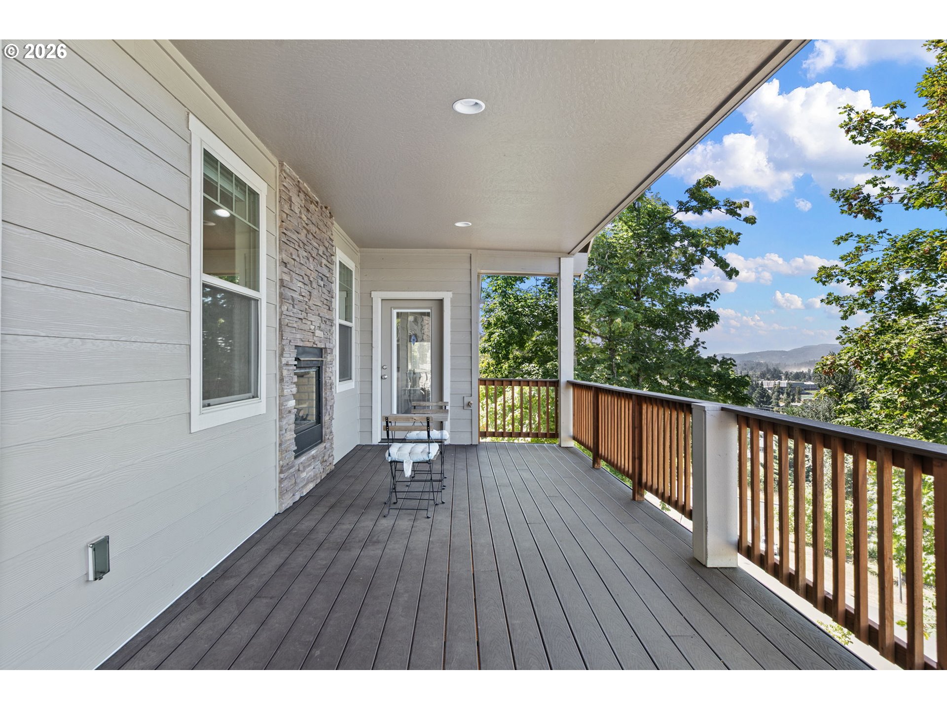 6451 Dogwood Street Springfield, OR 97478 - Photo 27 of 38 a balcony with wooden floor and some trees