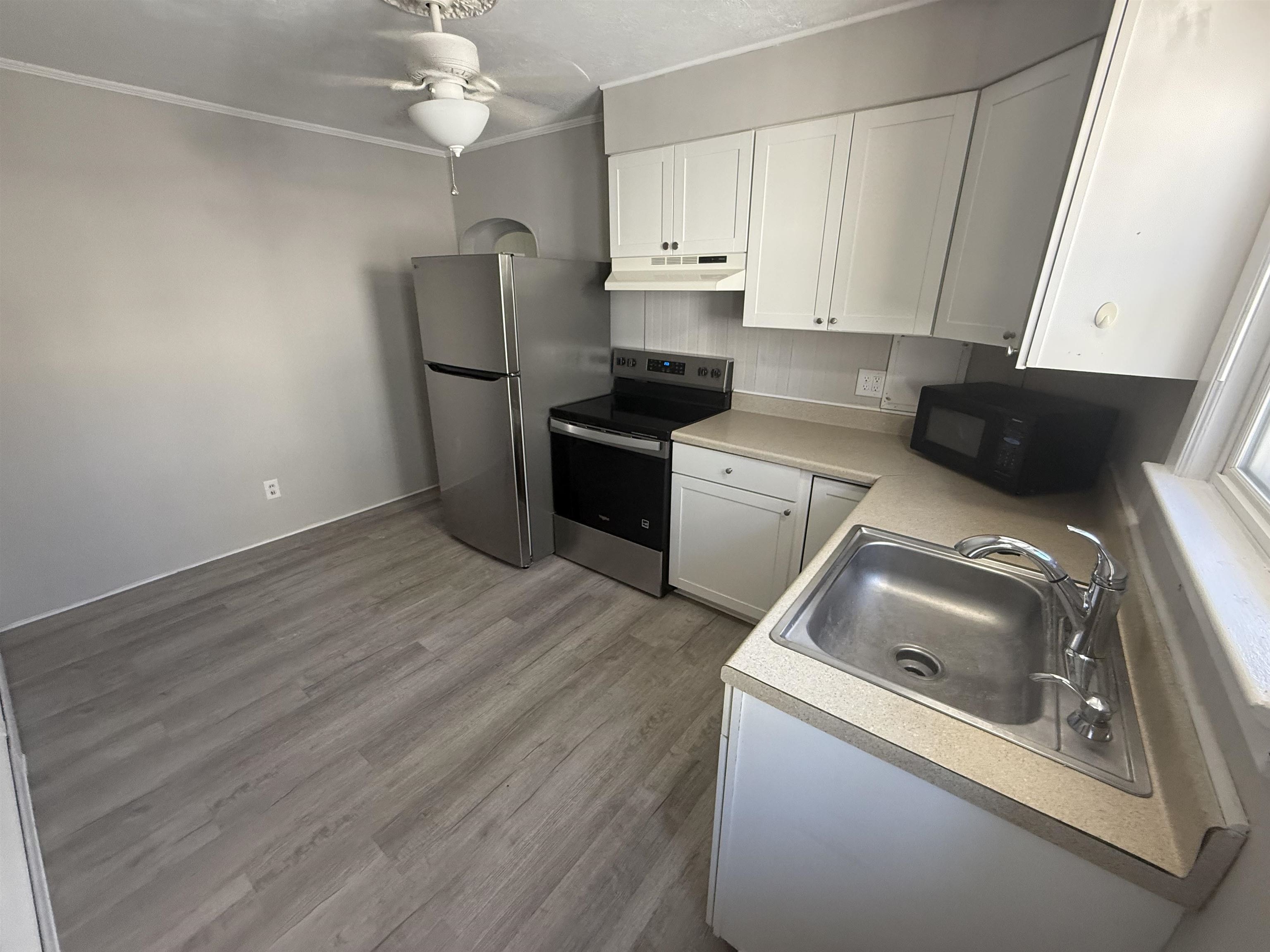 110 West Crocus Road, Unit 2 Wildwood Crest, NJ 08260 - Photo 2 of 8 a kitchen with a refrigerator sink and cabinets
