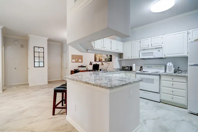 a kitchen with granite countertop a sink and cabinets