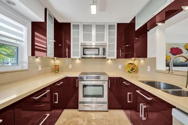 a kitchen with a sink and a stove top oven