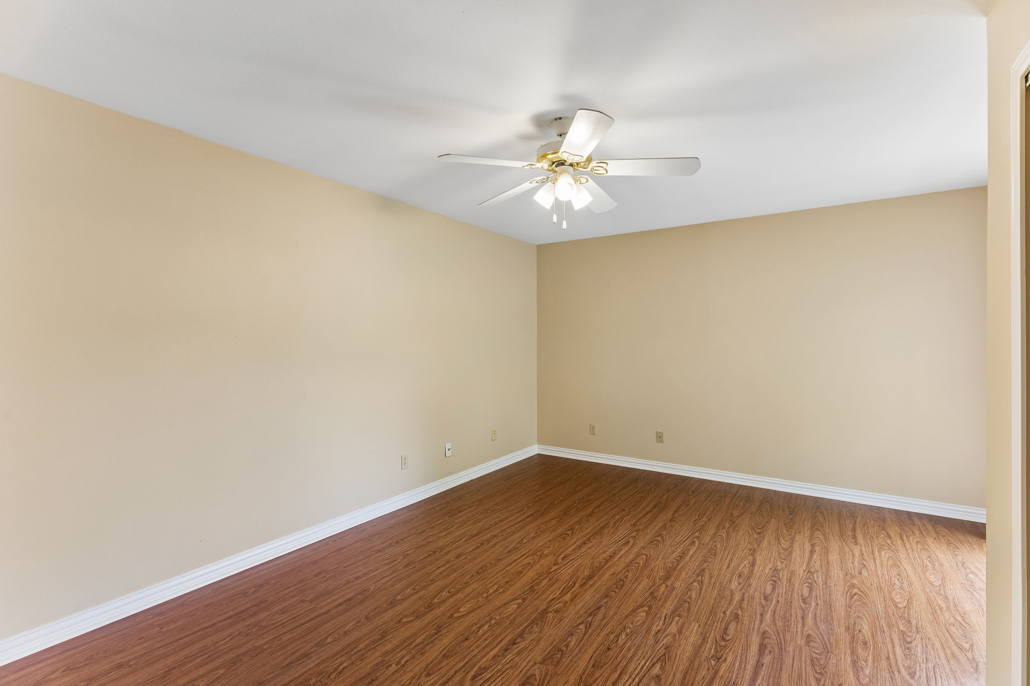 8340 Fathom Circle, Unit 103 Austin, TX 78750 - Photo 25 of 30 an empty room with wooden floor and fan