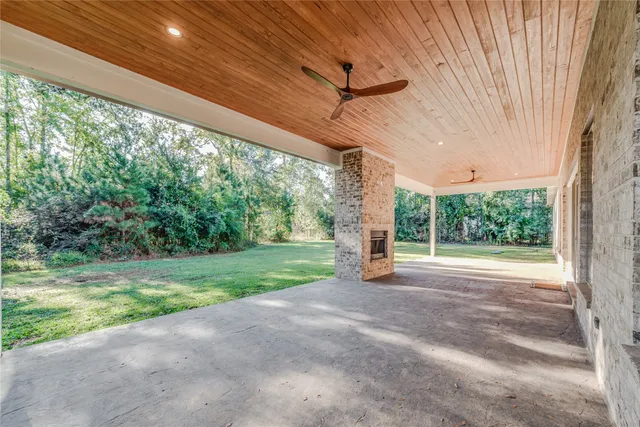 a view of a house with backyard and porch