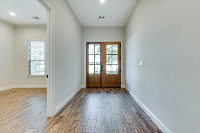 wooden floor in an empty room with a window