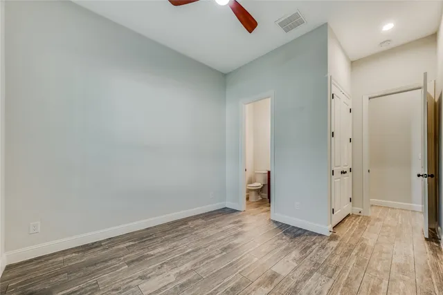 a view of an empty room and wooden floor