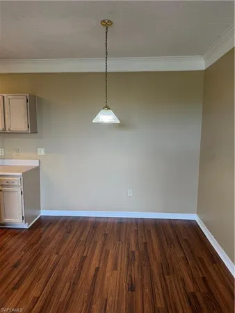a view of a room with wooden floor and a window