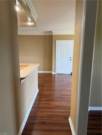 a view of a hallway with wooden floor