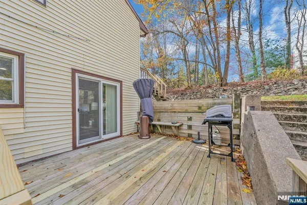 a kitchen with stainless steel appliances granite countertop a stove top oven a sink dishwasher a dining table and chairs