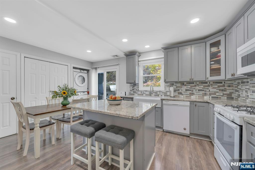 39 Delaware Road West Milford, NJ 07421 - Photo 14 of 37 a kitchen with granite countertop white cabinets a table and chairs in it