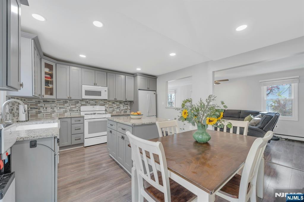 39 Delaware Road West Milford, NJ 07421 - Photo 15 of 37 a kitchen with stainless steel appliances granite countertop a stove top oven a sink dishwasher a dining table and chairs