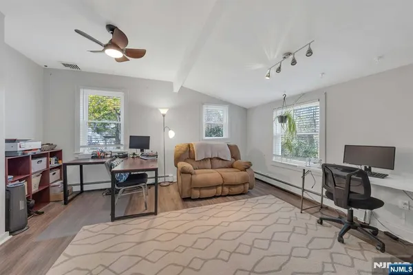 a spacious bedroom with a bed and a flat screen tv