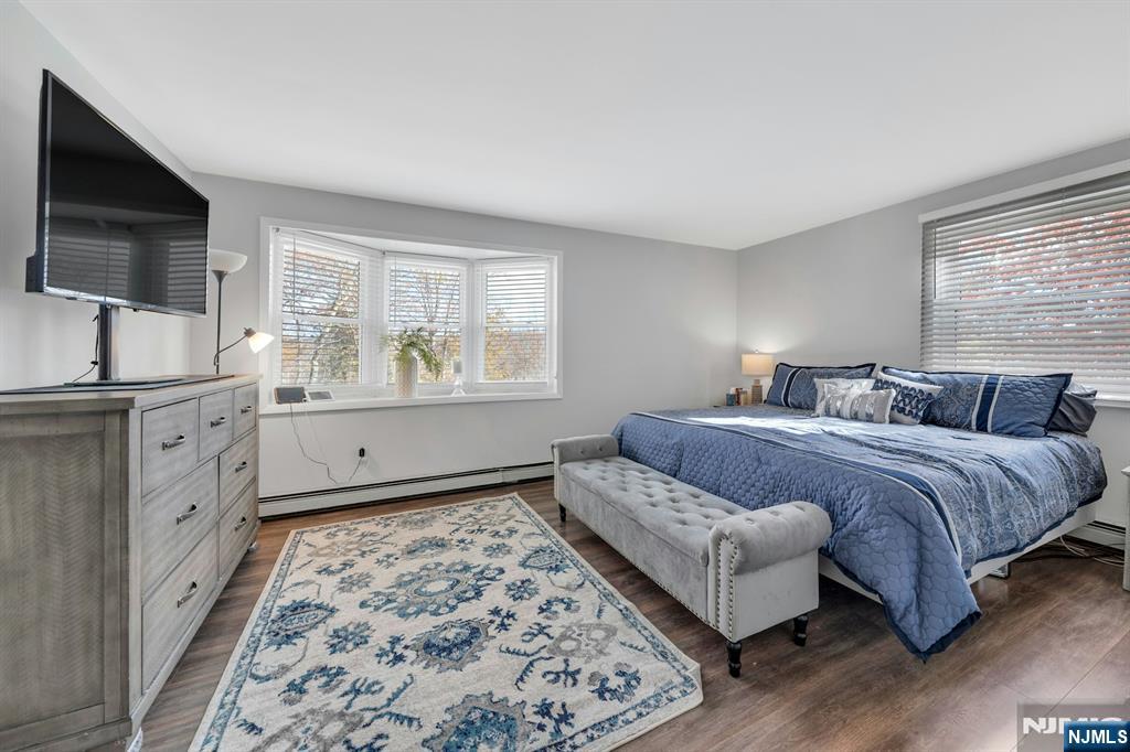 39 Delaware Road West Milford, NJ 07421 - Photo 21 of 37 a spacious bedroom with a bed and a flat screen tv