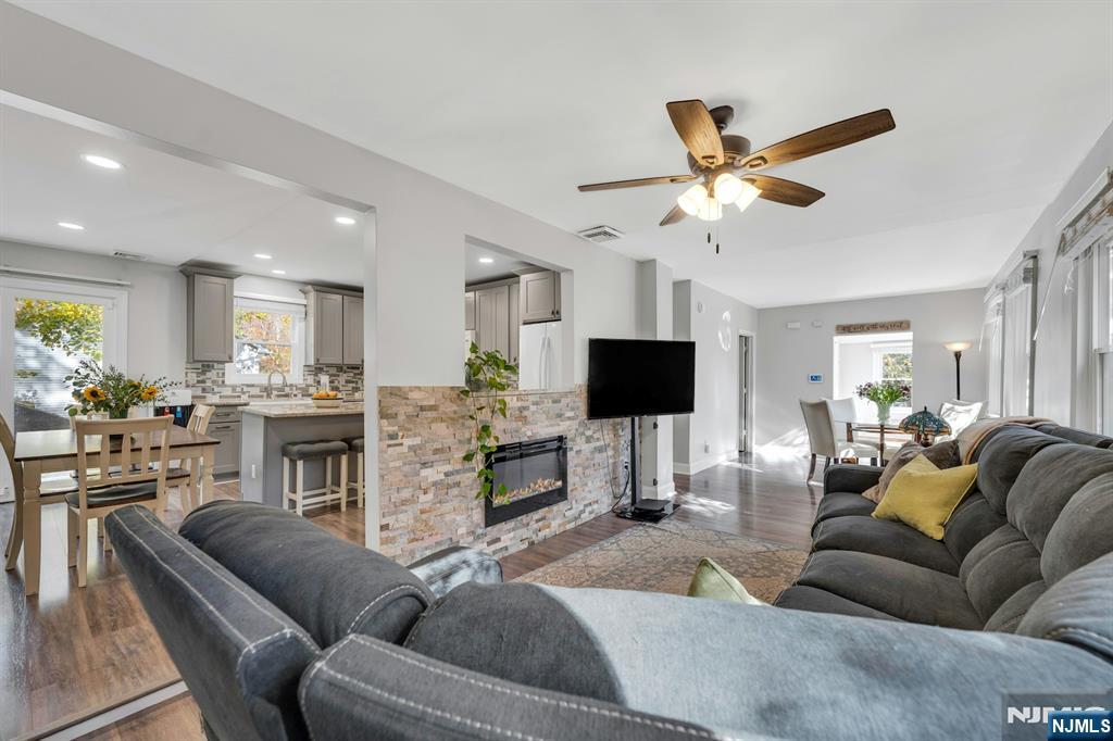 39 Delaware Road West Milford, NJ 07421 - Photo 9 of 37 a living room with furniture and a flat screen tv with kitchen view