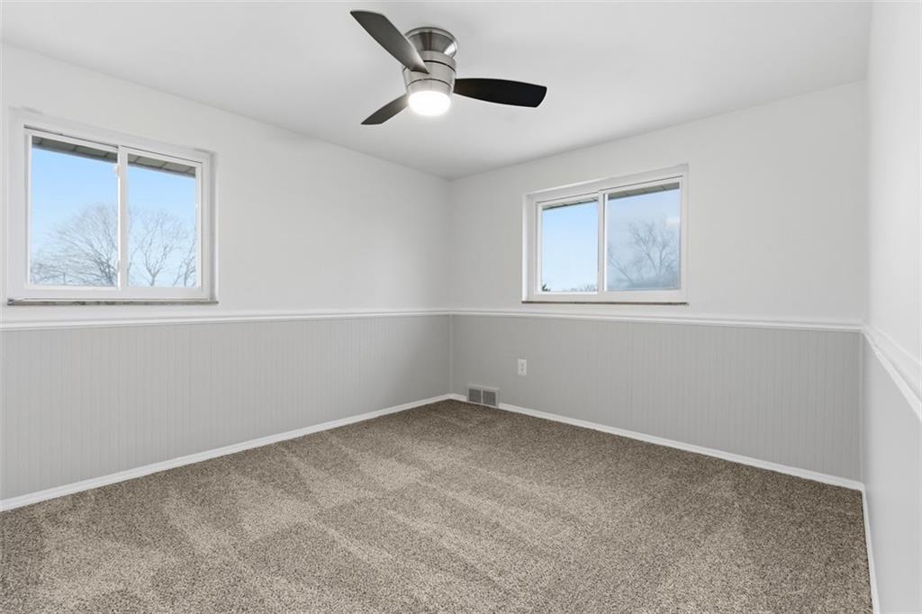 111 Crest Drive Monaca, PA 15061 - Photo 16 of 37 an empty room with a window and a ceiling fan