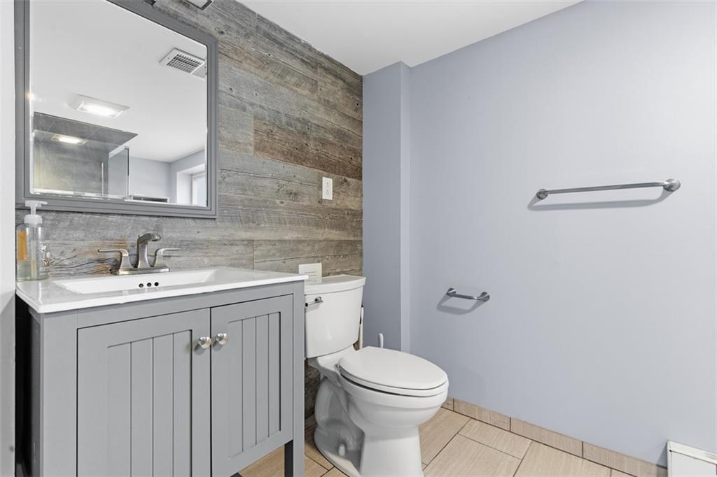 111 Crest Drive Monaca, PA 15061 - Photo 27 of 37 a bathroom with a toilet a sink a mirror and vanity