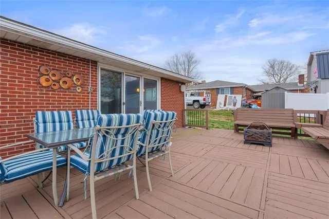 an aerial view of residential house with outdoor space and trees all around