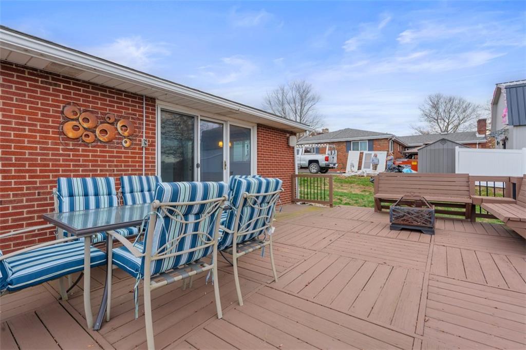 111 Crest Drive Monaca, PA 15061 - Photo 32 of 37 a view of a roof deck with table and chairs with wooden floor and fence