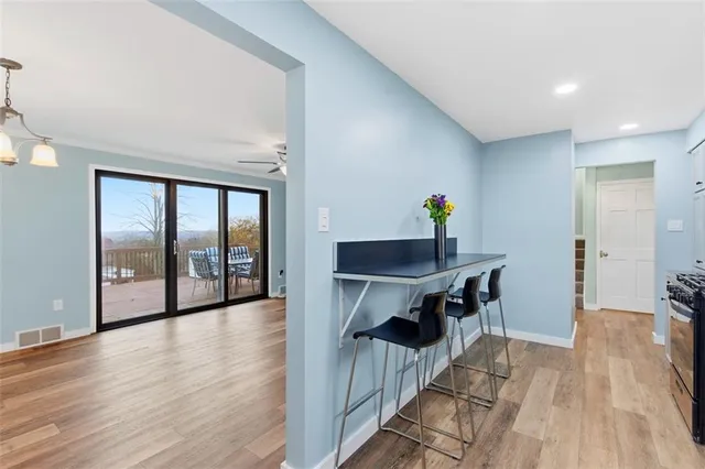 a view of a room with wooden floor and furniture