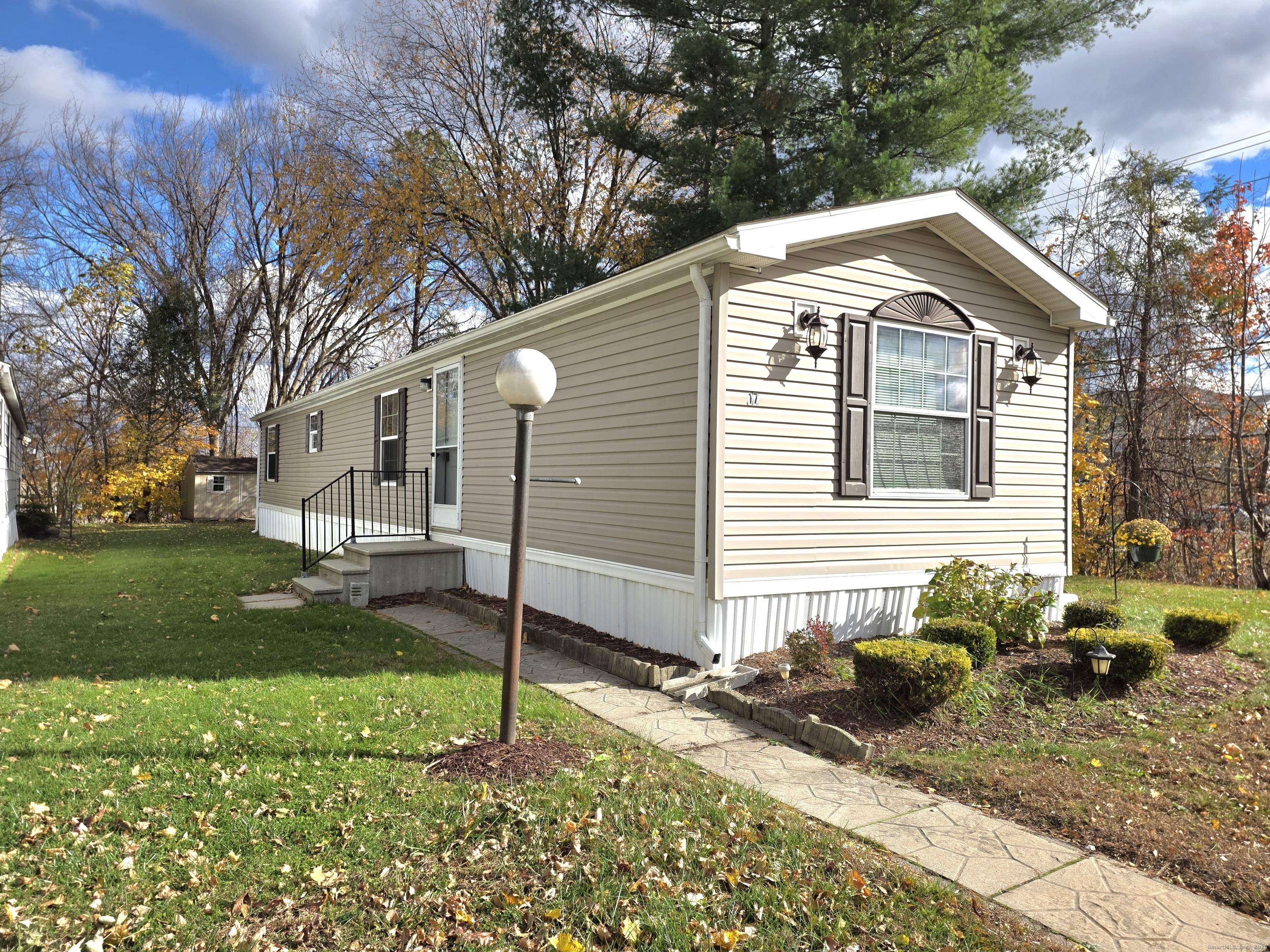 9 N Road, Unit 17 East Windsor, CT 06088 - Photo 1 of 24 a front view of a house with garden