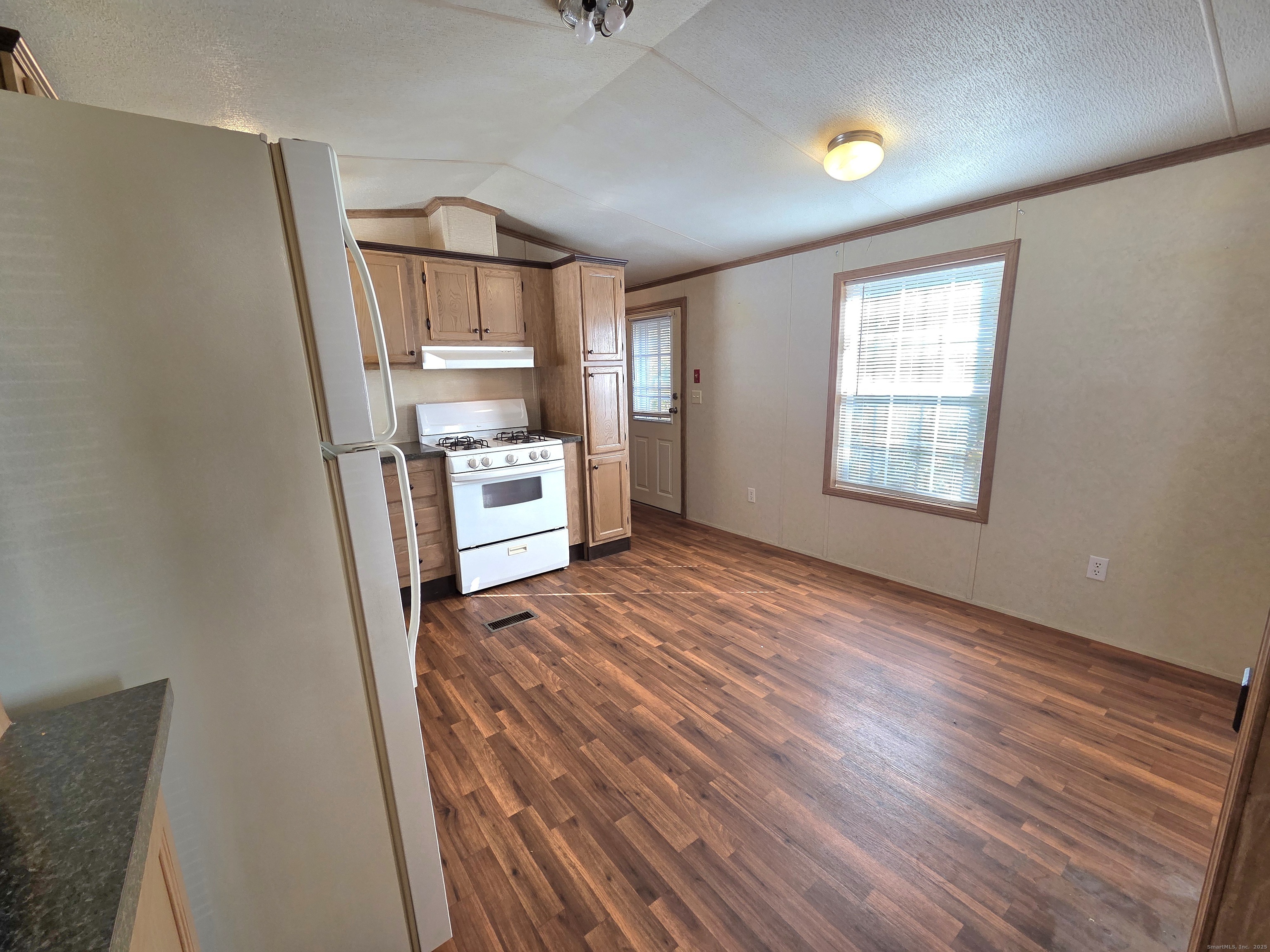 9 N Road, Unit 17 East Windsor, CT 06088 - Photo 11 of 24 a view of a kitchen with furniture and wooden floor