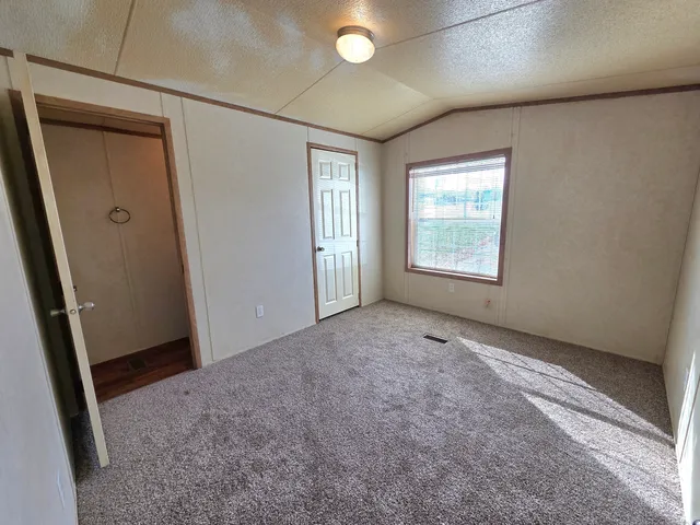 an empty room with windows and closet