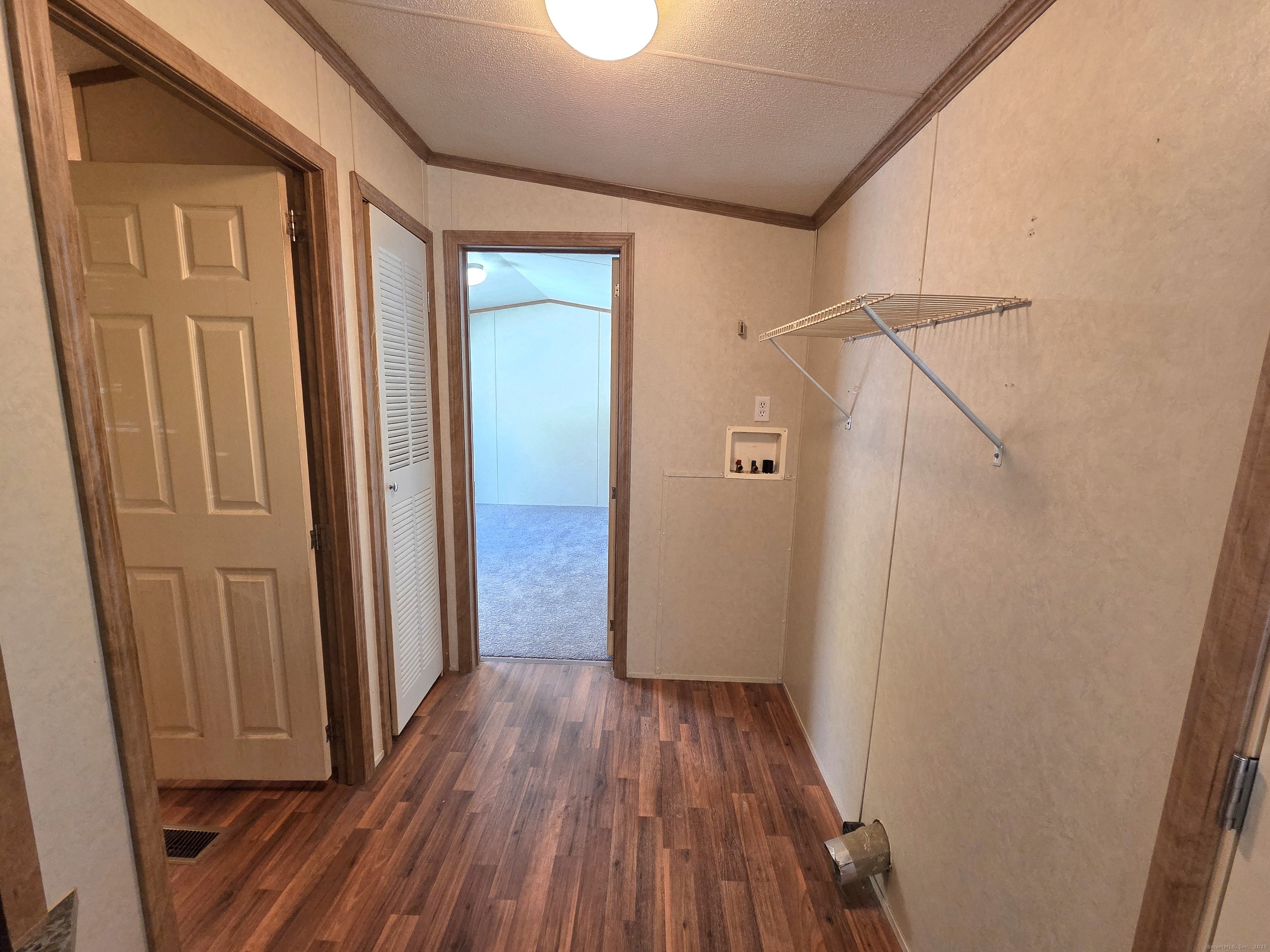 9 N Road, Unit 17 East Windsor, CT 06088 - Photo 16 of 24 a view of a hallway with wooden floor and staircase