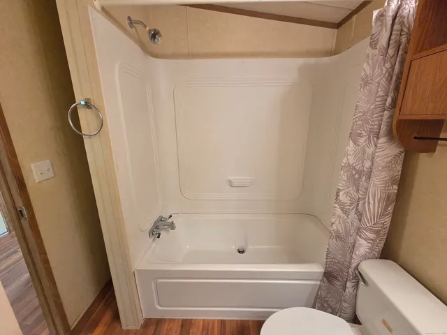 a bathroom with a tub and a shower