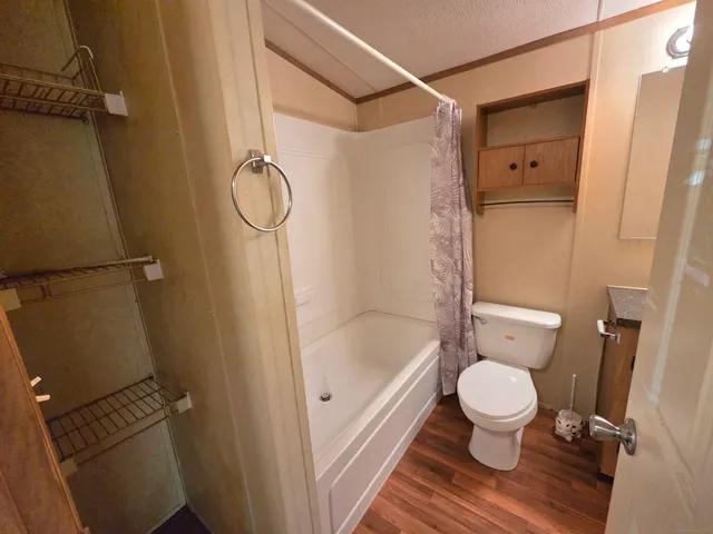 a bathroom with a toilet and a shower