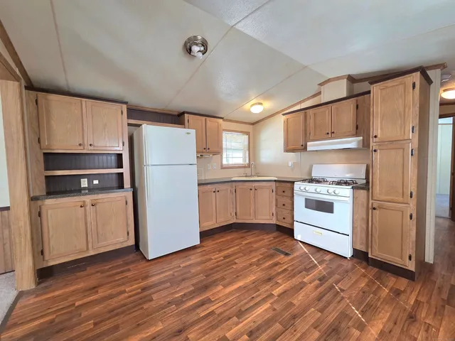 a kitchen with white cabinets and white appliances
