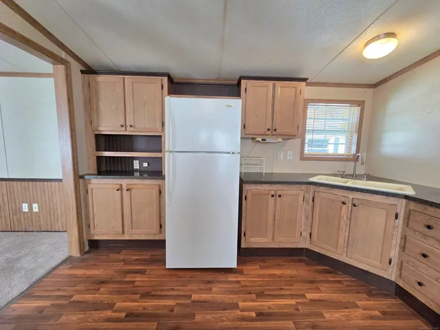 a kitchen with cabinets and a refrigerator