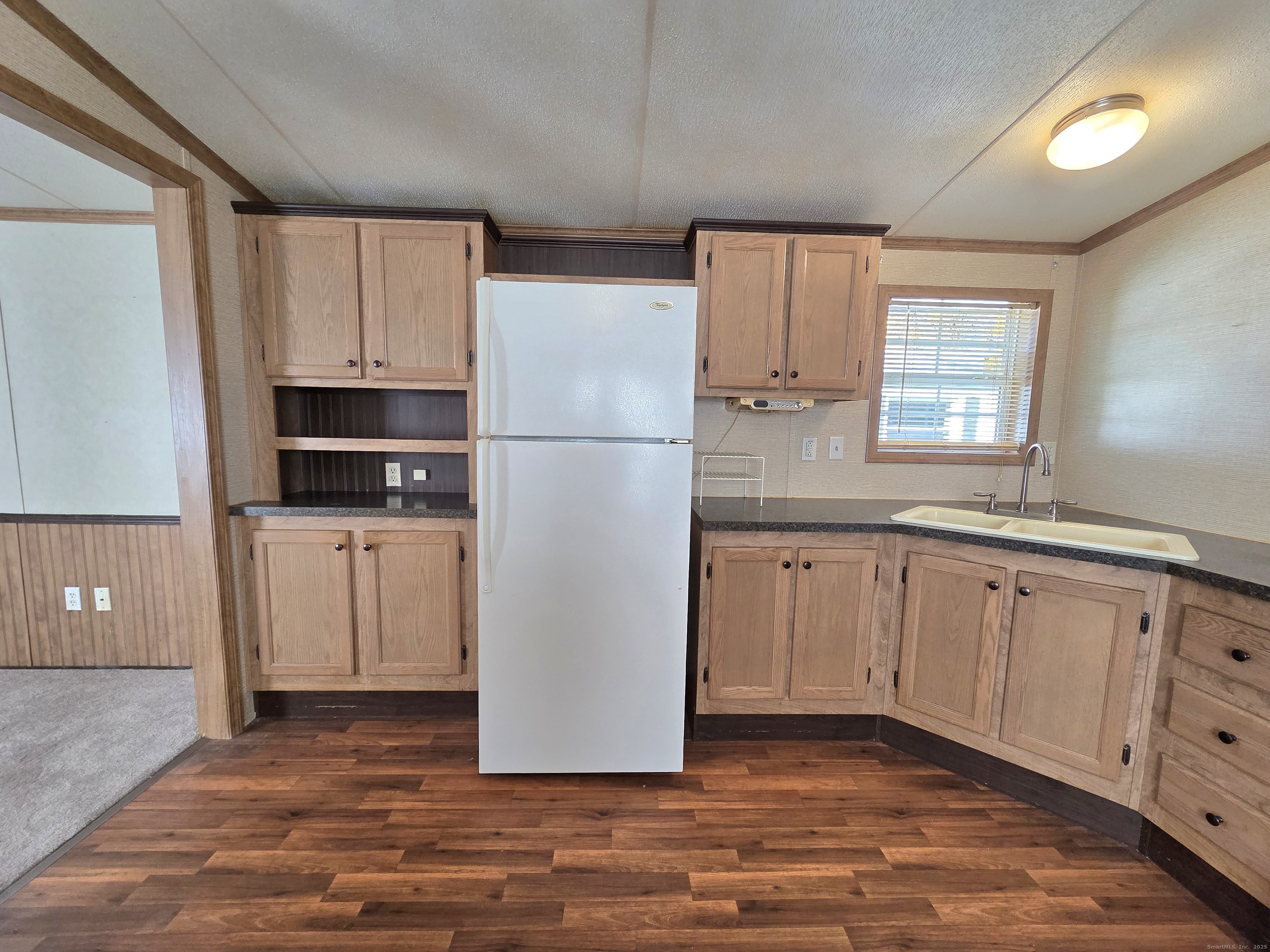 9 N Road, Unit 17 East Windsor, CT 06088 - Photo 9 of 24 a kitchen with cabinets and a refrigerator