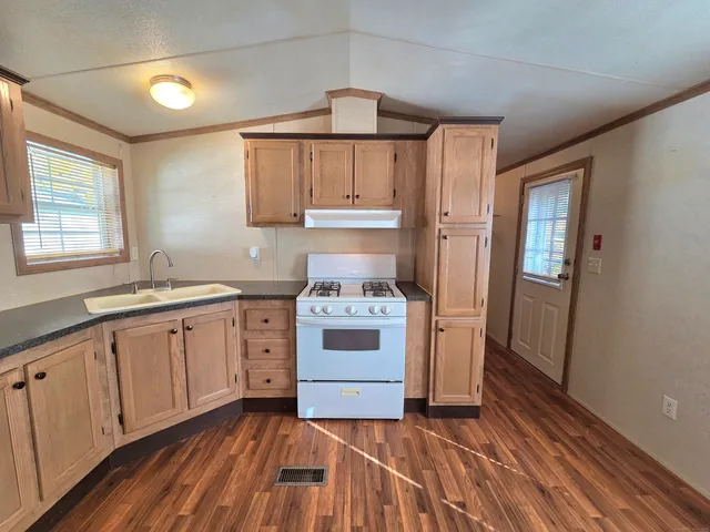 a kitchen with a stove cabinets and a sink