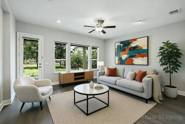 a living room with furniture a table and a large window